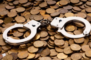 Hand cuffs and coins as security concept